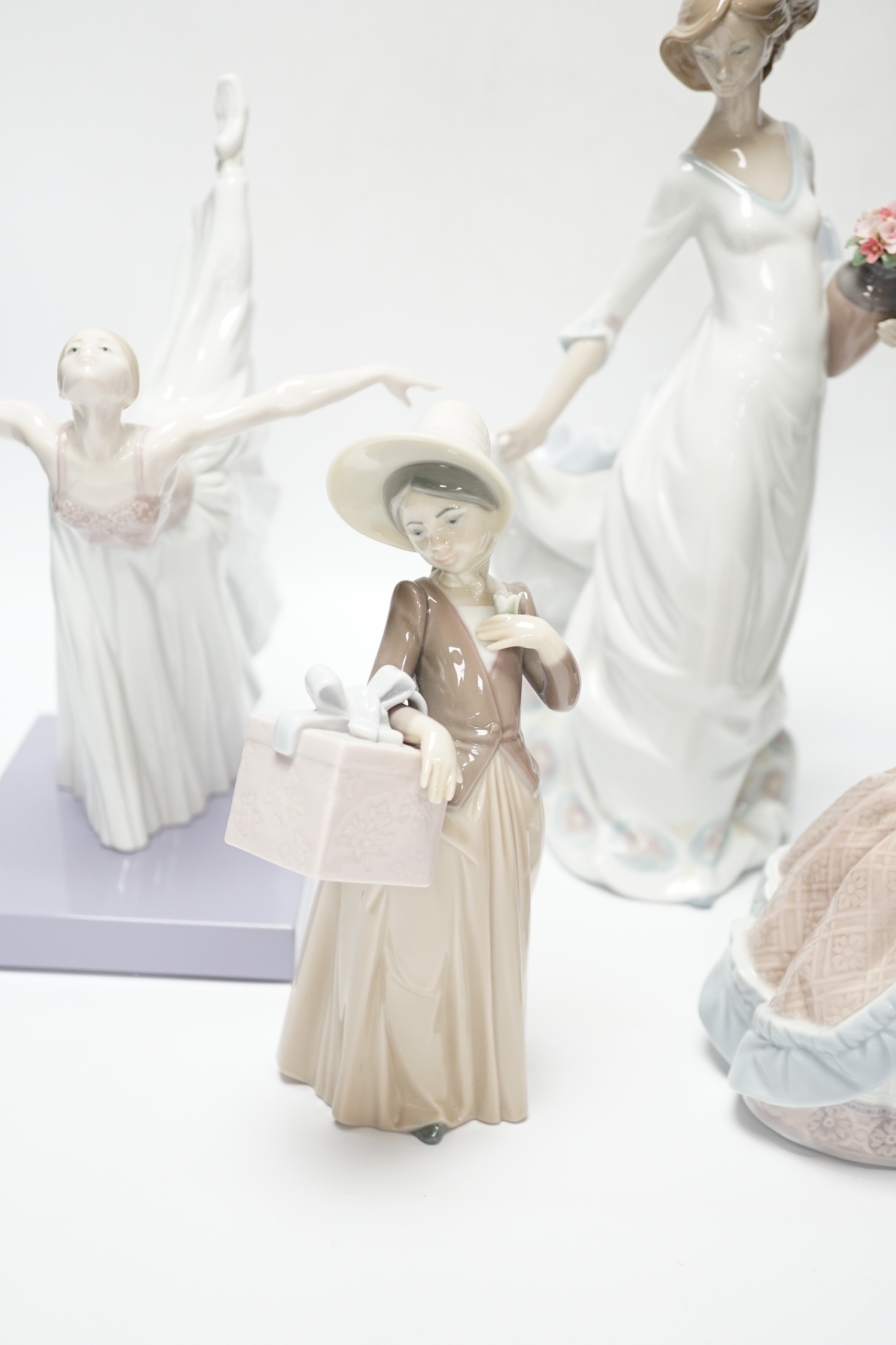 Four Lladro figurines; Reverie Moment, a model of a Ballet Dancer, and three other figurines (only two boxed)